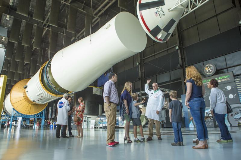 Visitors standing beneath a Saturn V rocket inside the U.S. Space & Rocket Center in Huntsville