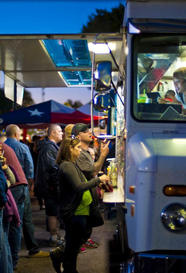 Patrons order from a food truck in Huntsville, AL