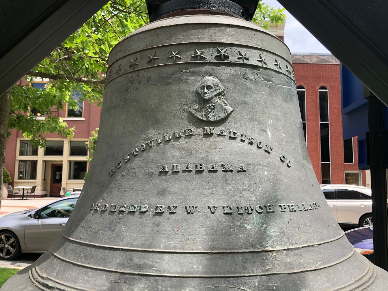 A close-up image of the Huntsville Madison County Courthouse Bell with legible text.