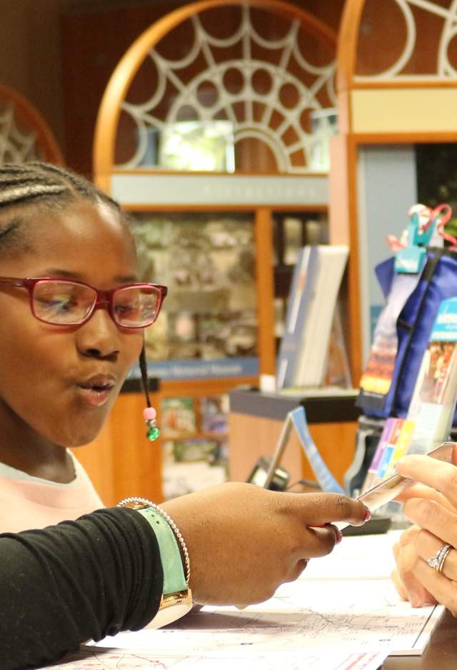 Visitors getting brochures at the Huntsville/Madison County Convention & Visitors Bureau Center