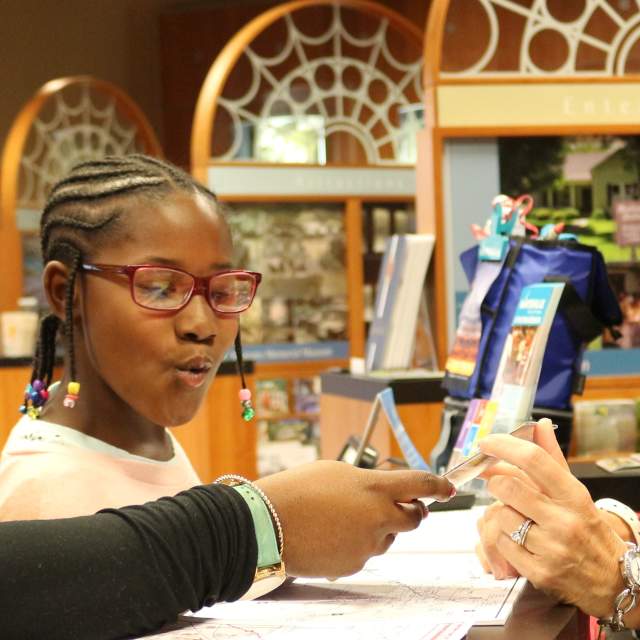 Visitors getting brochures at the Huntsville/Madison County Convention & Visitors Bureau Center