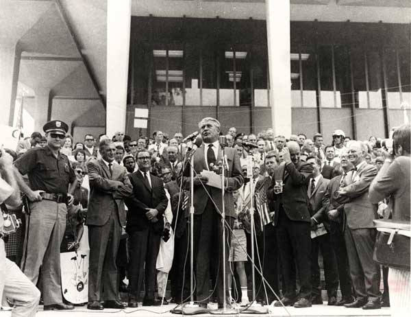 This image is of a news conference on the 1969 Lunar Landing Celebration in front of the Courthouse.