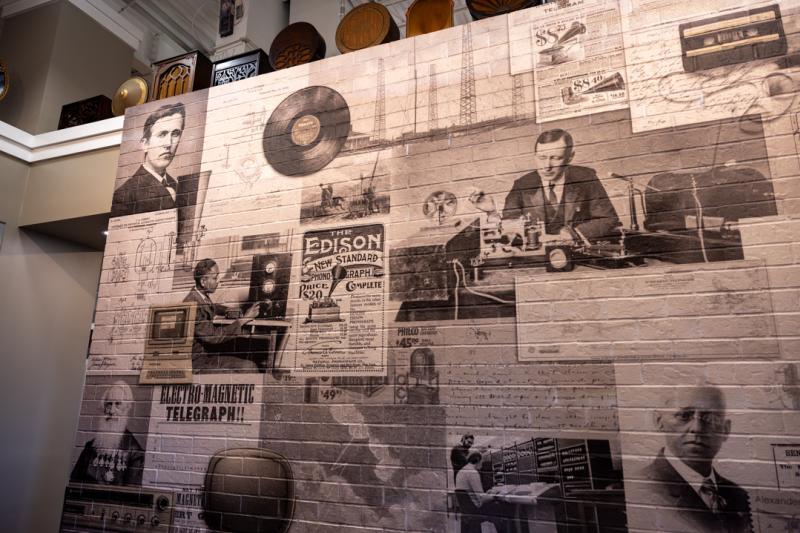 Large mural depicting early communication technology and inventors inside a museum in Huntsville