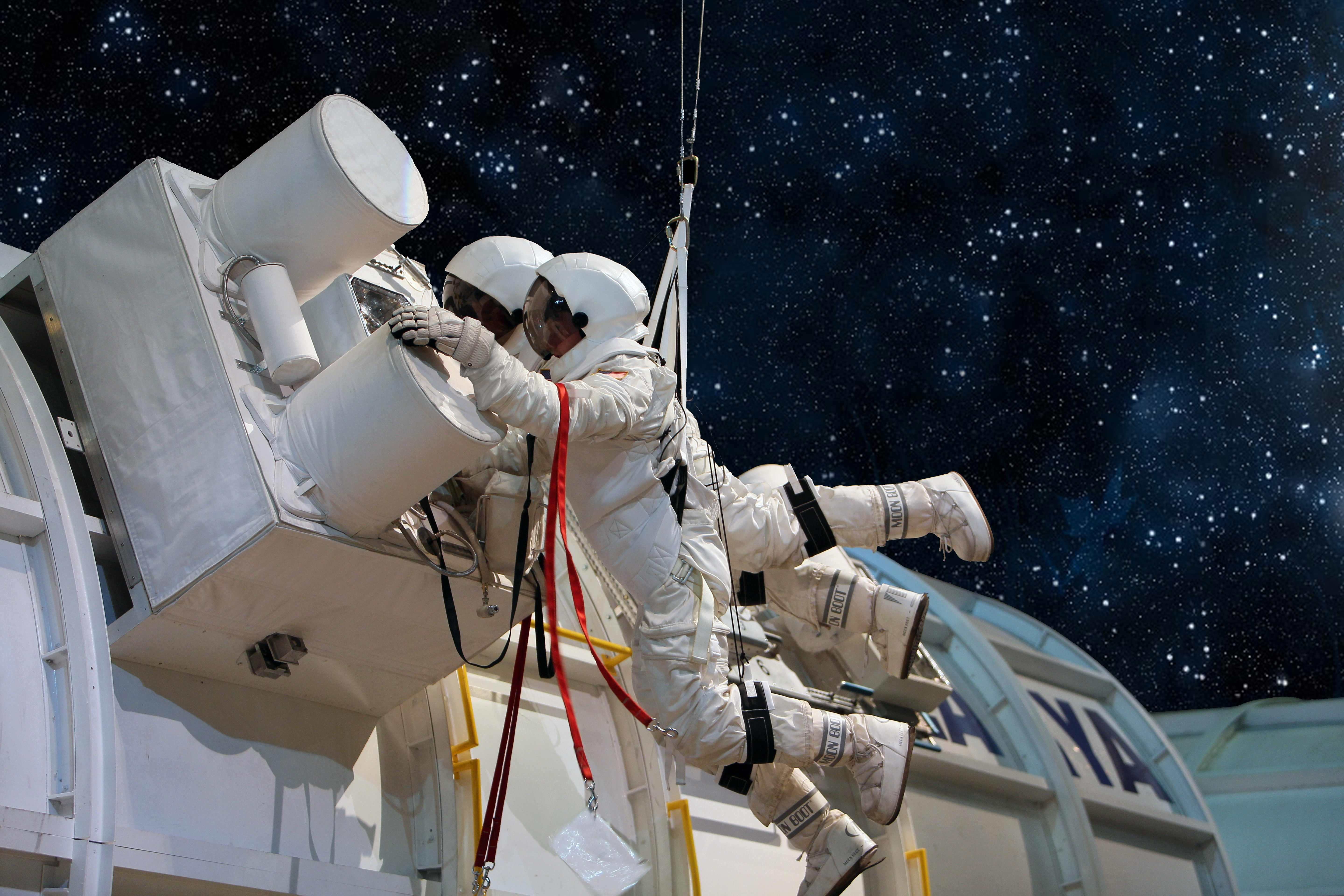 Astronauts Working On A Machine In Space